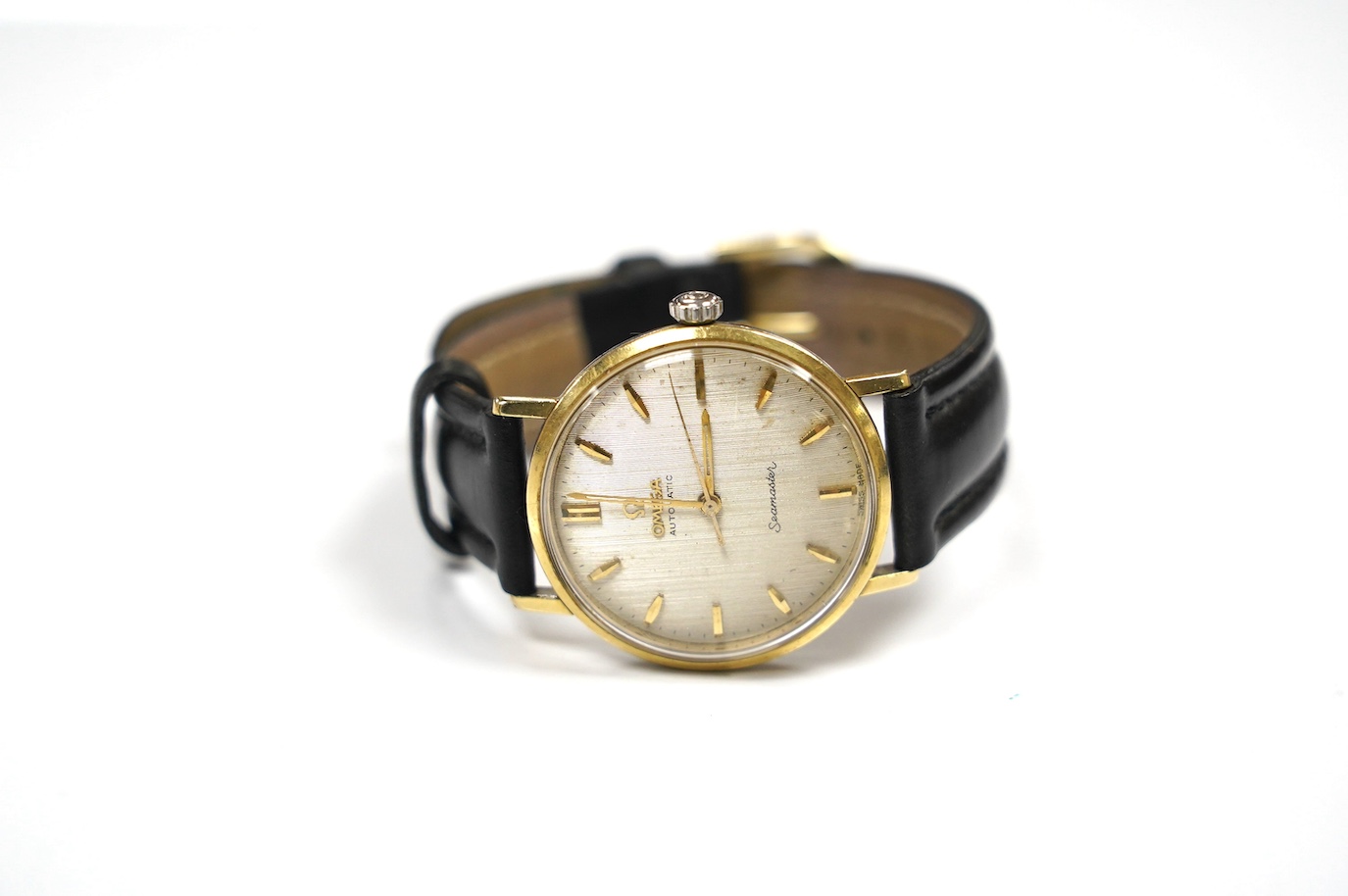 A gentleman's steel and gold plated Omega Seamaster automatic wrist watch, on an associated leather strap, case diameter 34mm, with engraved inscription. Condition - poor to fair